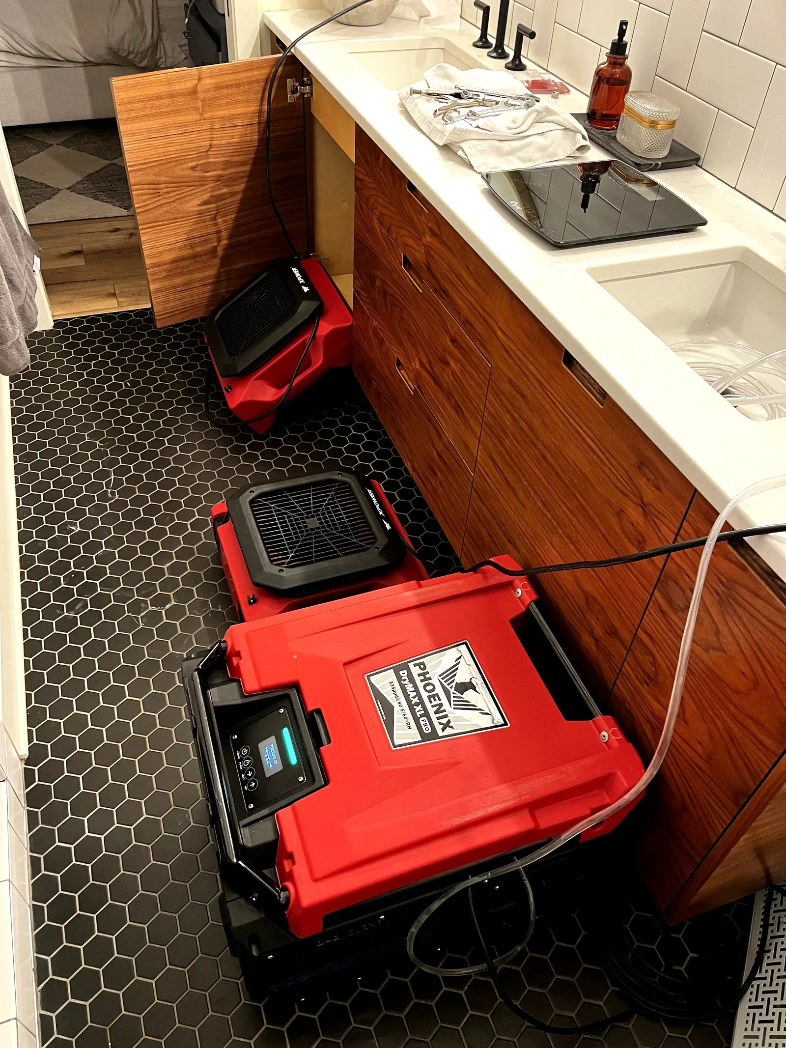 Commercial Phoenix dehumidifier running in a water-damaged Grand Rapids bathroom