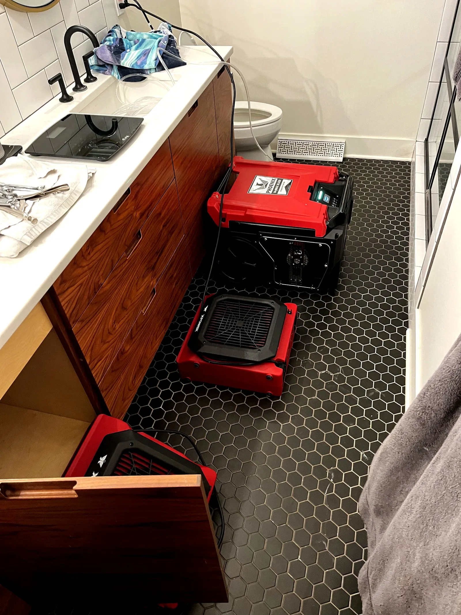 Professional drying equipment deployed in bathroom — West Michigan